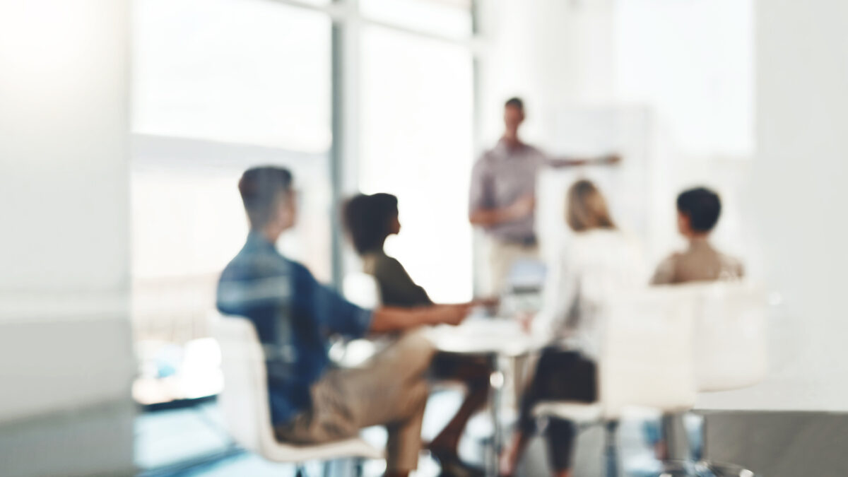 Defocused shot of a group of businesspeople having a meeting in an office