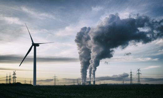 a coal burning power plant with pollution and electricity pylons