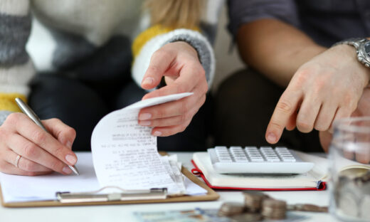 Close-up view of man and woman calculating expenses