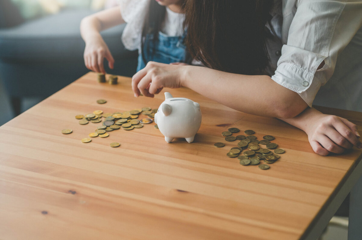 Mother and her daughter count coins