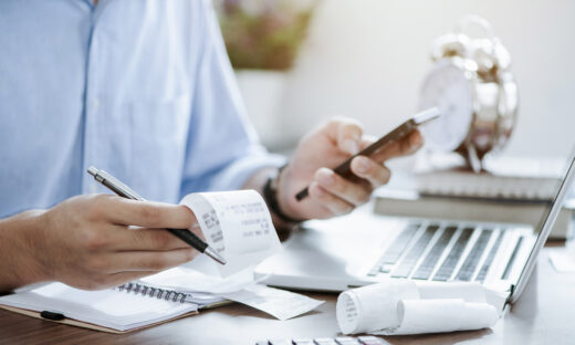 young man holding pen with bills working for calculate business data, taxes, bills payment,