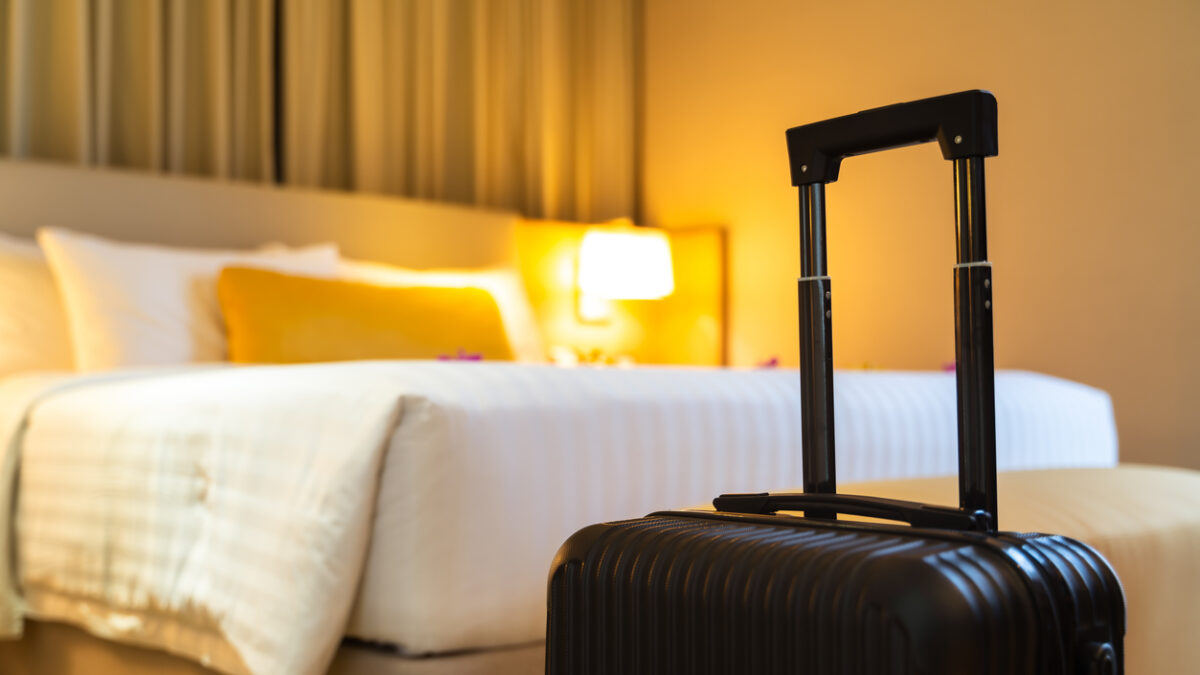 Suitcase delivered standing in hotel room