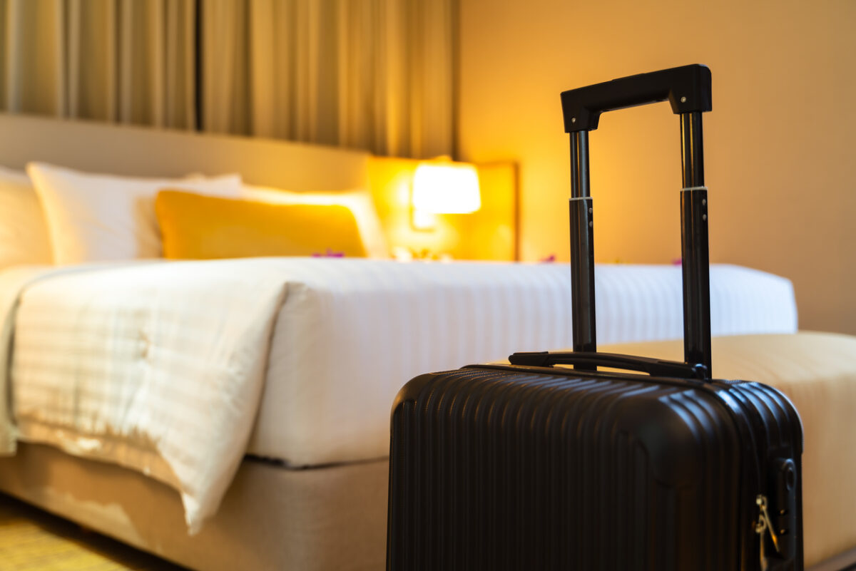 Suitcase delivered standing in hotel room