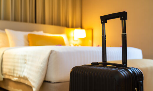 Suitcase delivered standing in hotel room