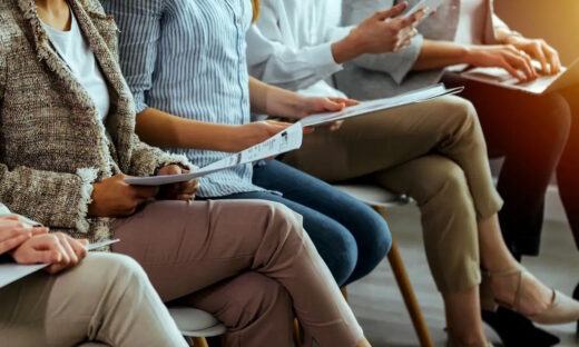 business people sitting on chairs in waiting room