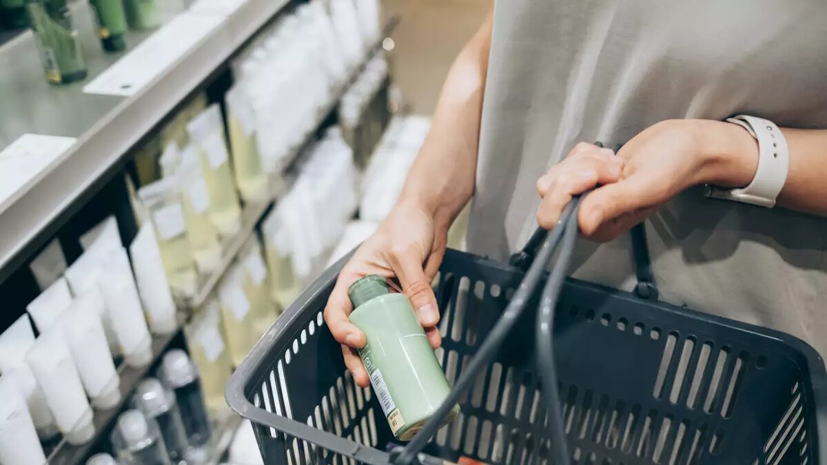 A female costumer holding a basket while shopping