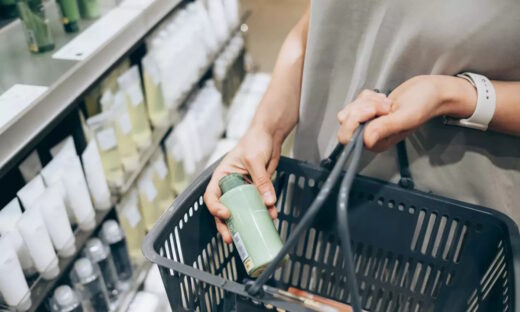 A female costumer holding a basket while shopping