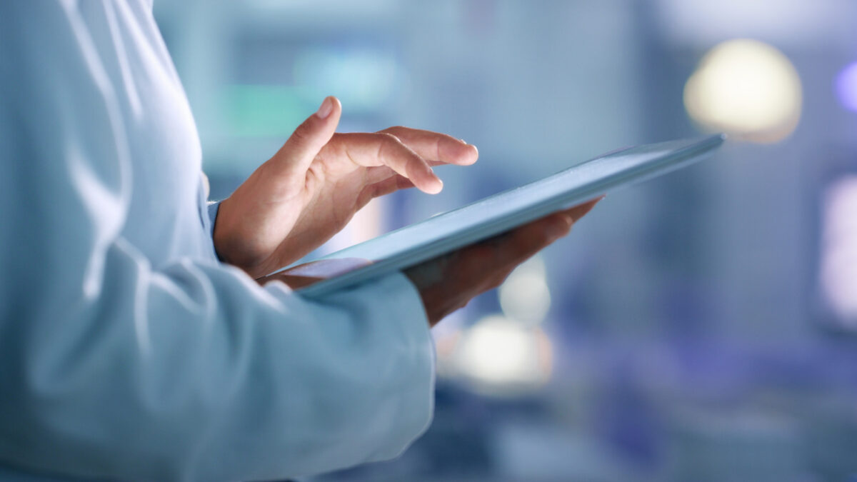 Doctor, researcher or scientist browsing the internet on a tablet for information while working at a lab, science facility or hospital. Expert, medical professional or surgeon searching the internet