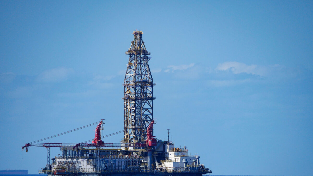 A large offshore oil rig in the middle of a vast expanse of ocean