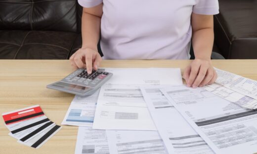 A woman pressing the calculator for calculate the money for her dept