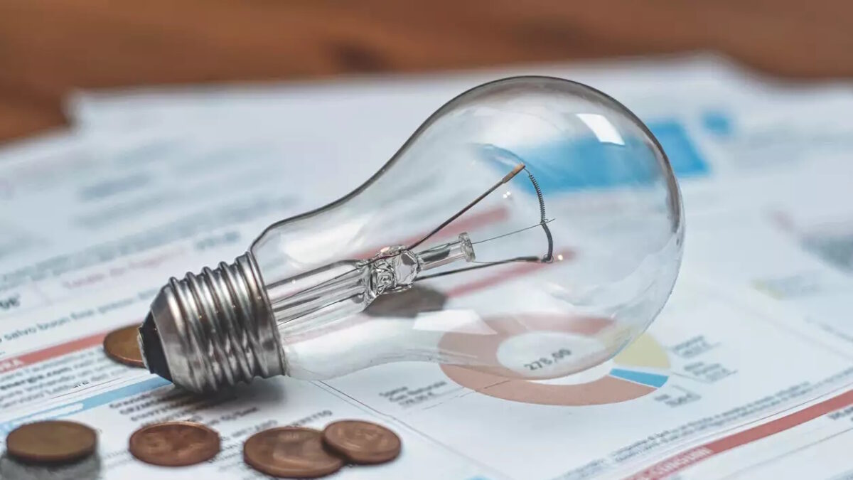 Lamp and coins on an electric bill