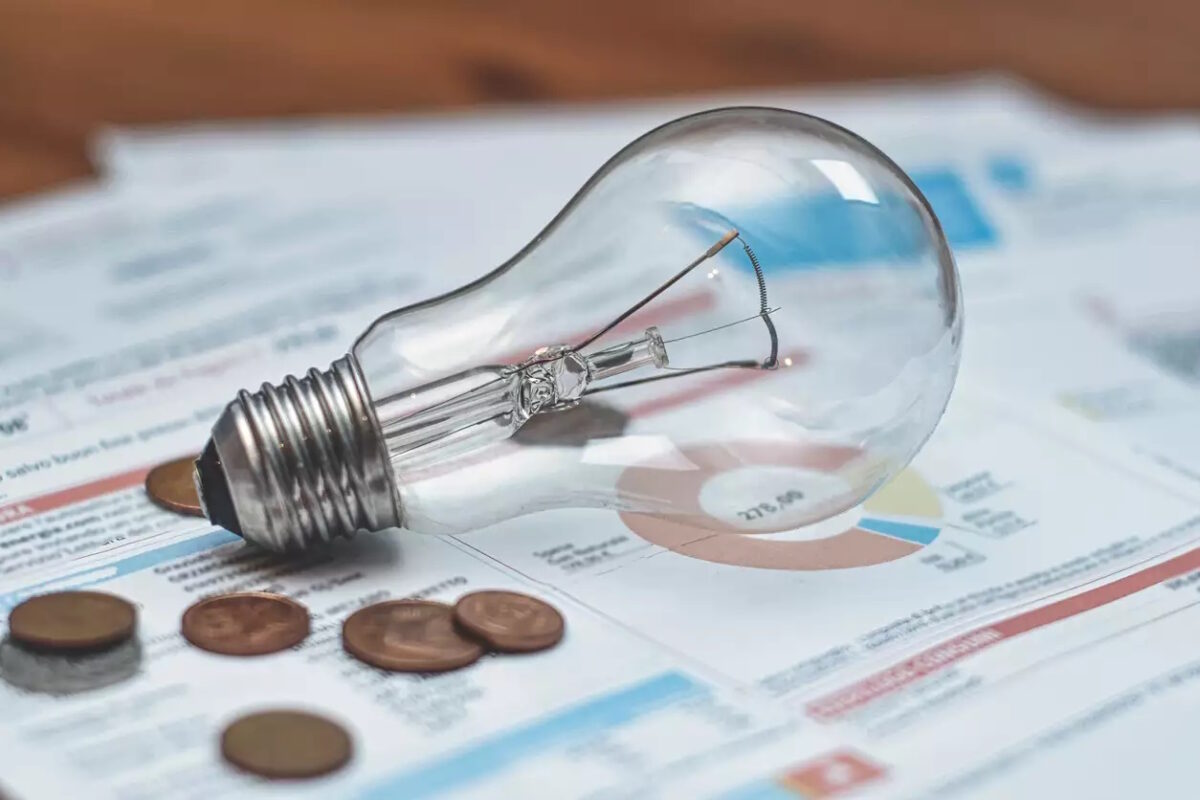 Lamp and coins on an electric bill