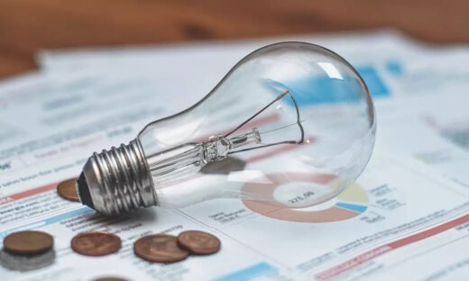 Lamp and coins on an electric bill