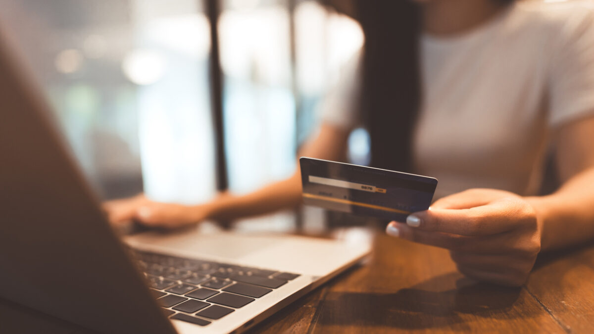 Woman hand consumer using creadit card and laptop