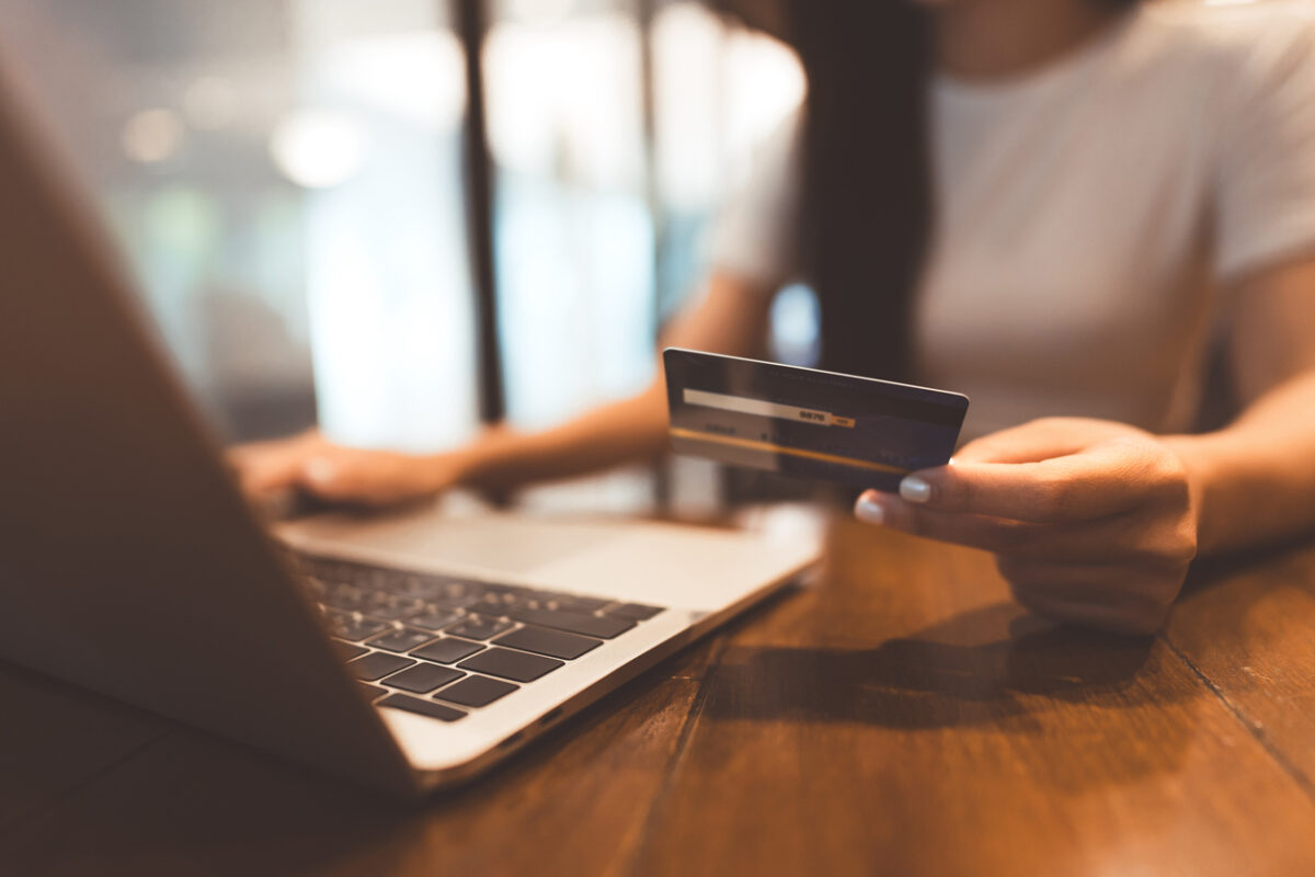 Woman hand consumer using creadit card and laptop