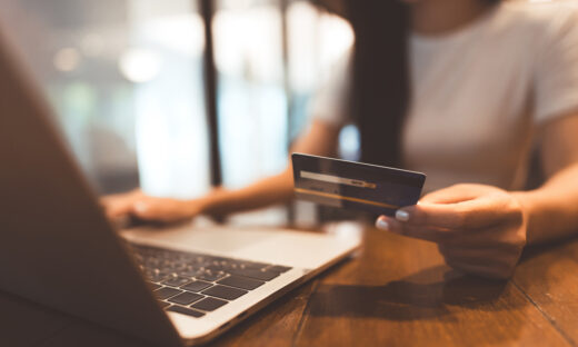 Woman hand consumer using creadit card and laptop