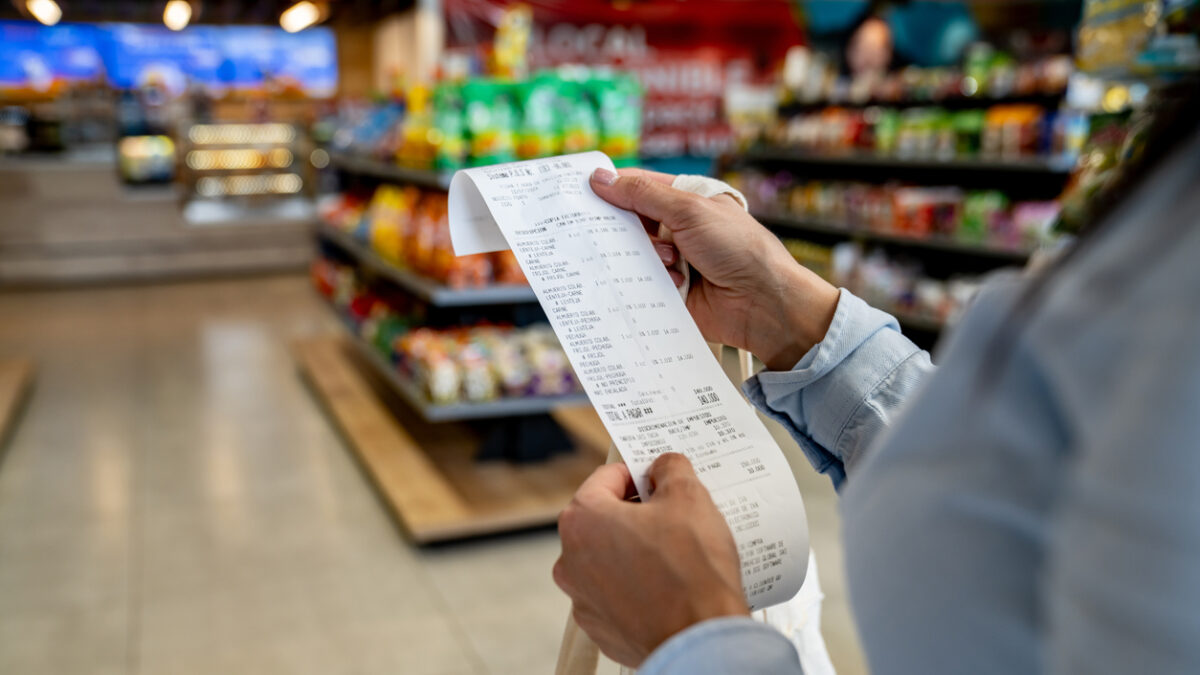 Woman shopping at a store and checking her receipt