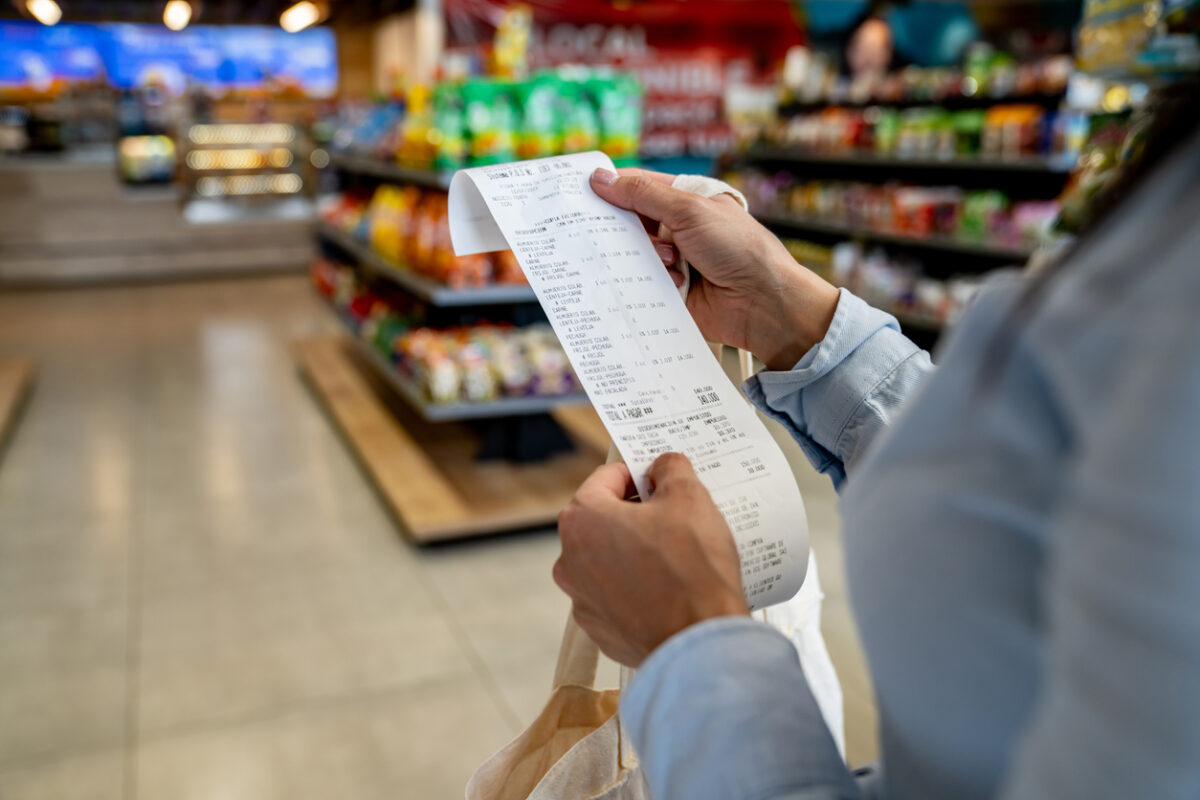 Woman shopping at a store and checking her receipt