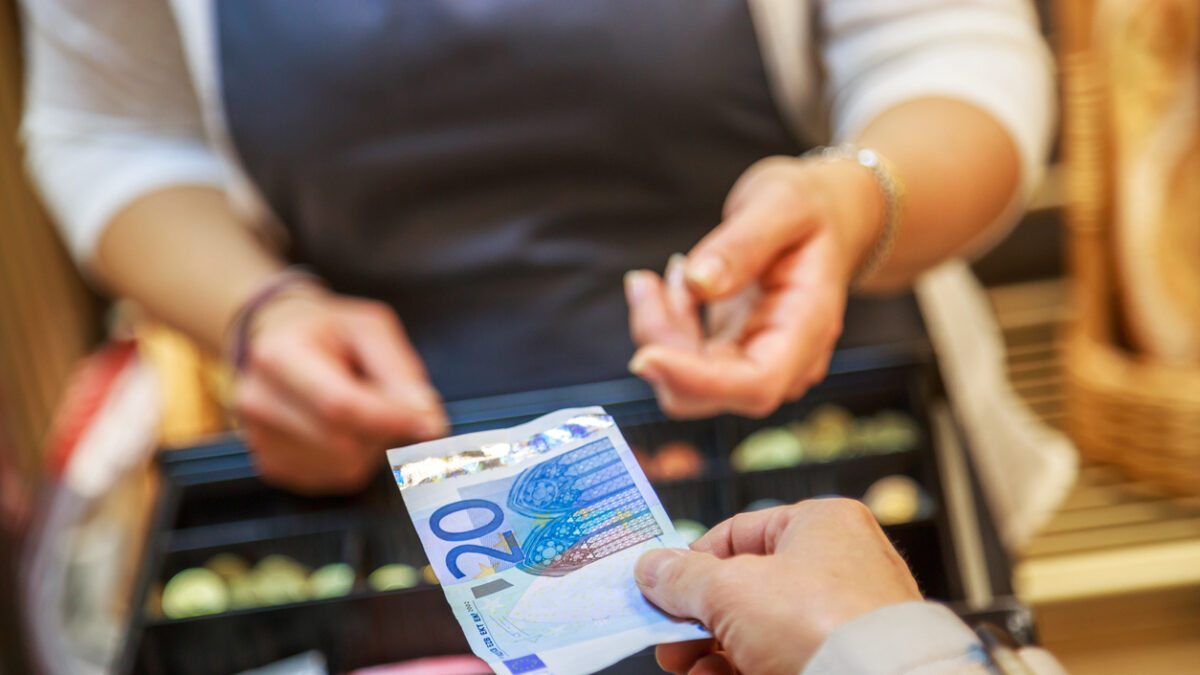 woman is paying In cash with euro