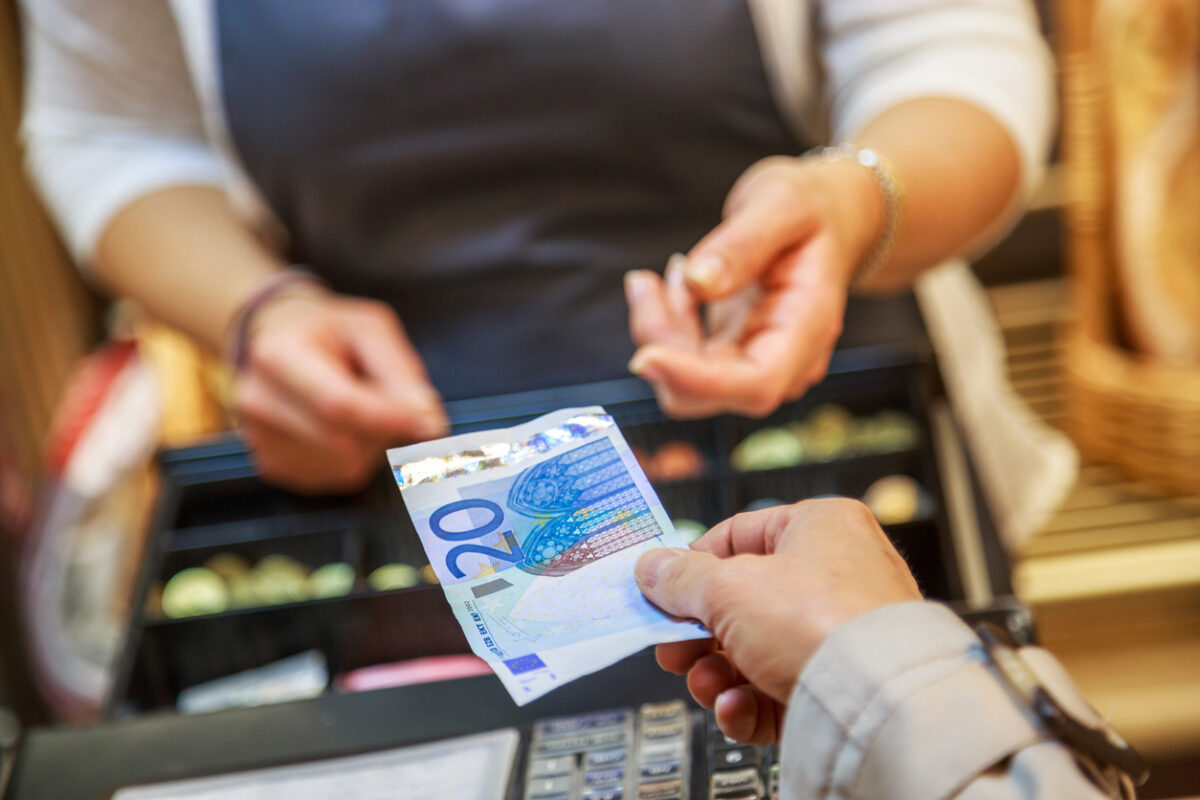 woman is paying In cash with euro