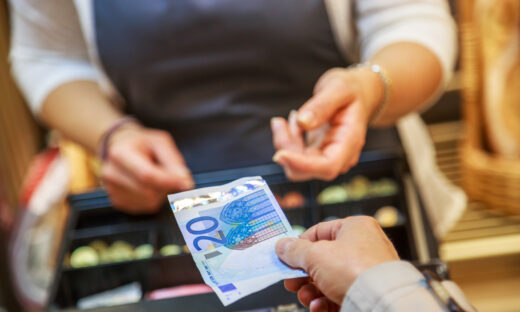 woman is paying In cash with euro