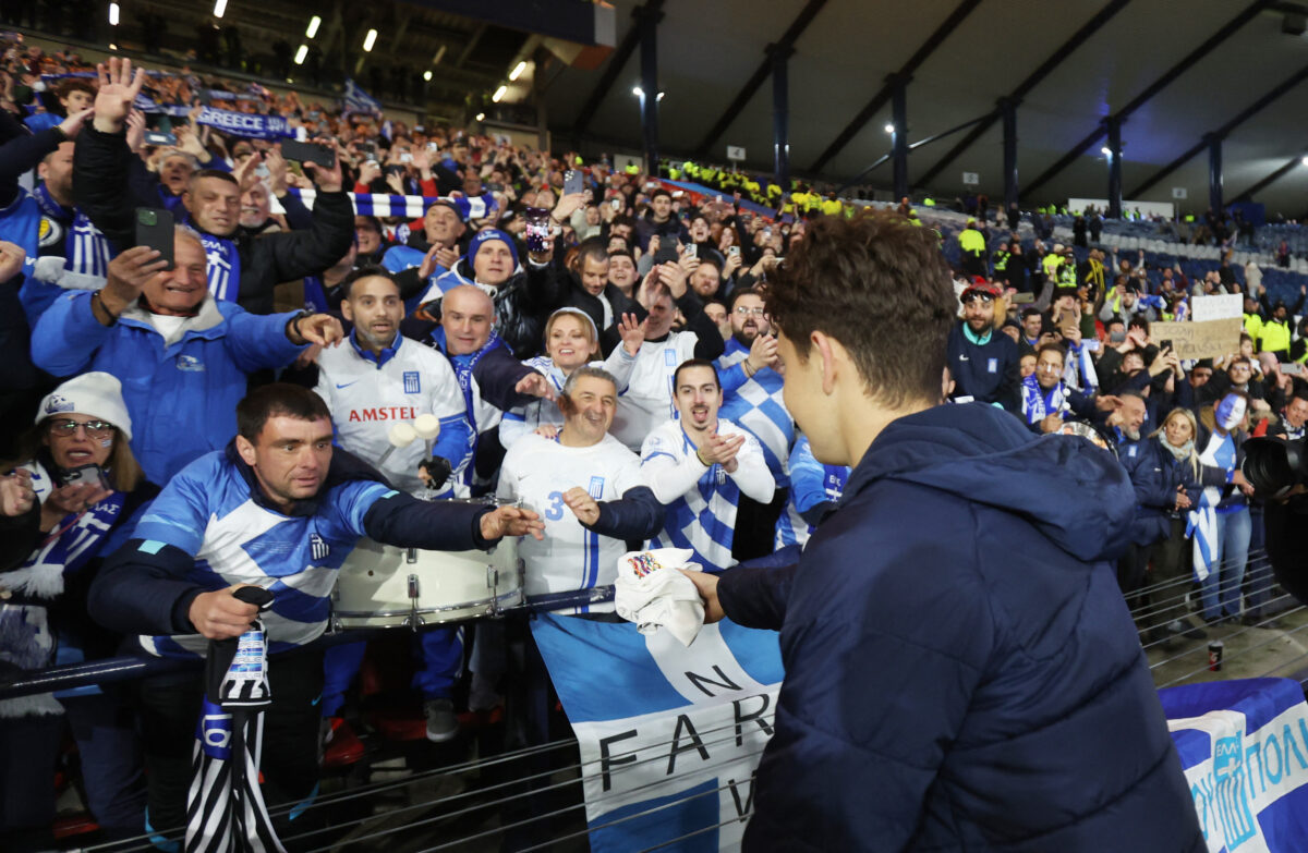 Soccer Football - Nations League - Play-offs - Second Leg - Scotland v Greece - Hampden Park, Glasgow, Scotland, Britain - March 23, 2025 Greece's Konstantinos Karetsas gives his shirt to a fan after the match REUTERS