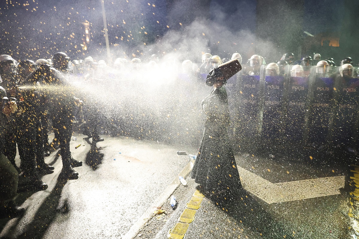 Police officers use pepper spray on a demonstrator wearing dervish clothes, during a protest on the day Istanbul Mayor Ekrem Imamoglu was jailed as part of a corruption investigation, in Istanbul, Turkey, March 23, 2025. REUTERS