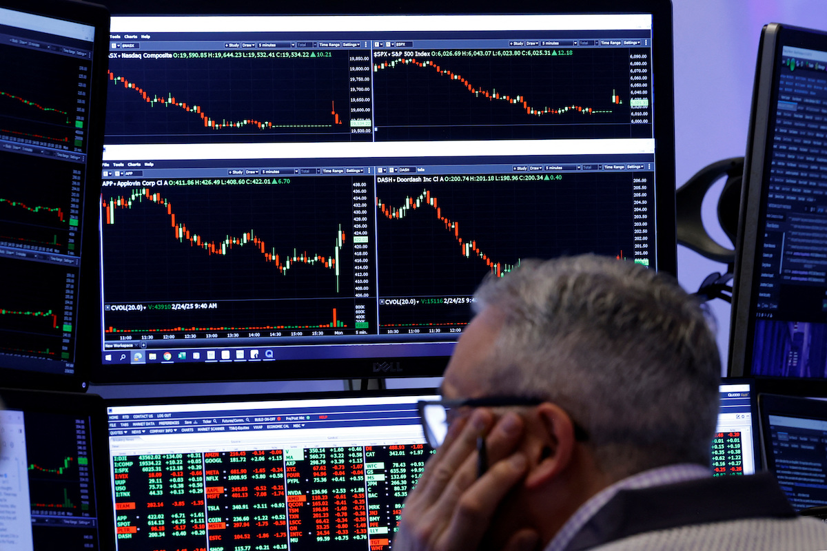 Traders work on the floor of the NYSE in New York