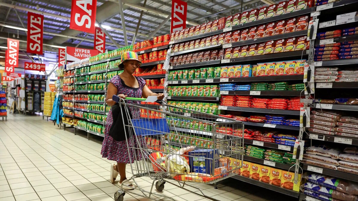 A woman uses a trolley as she shops at a Pick n Pay store