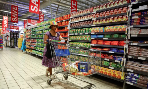 A woman uses a trolley as she shops at a Pick n Pay store